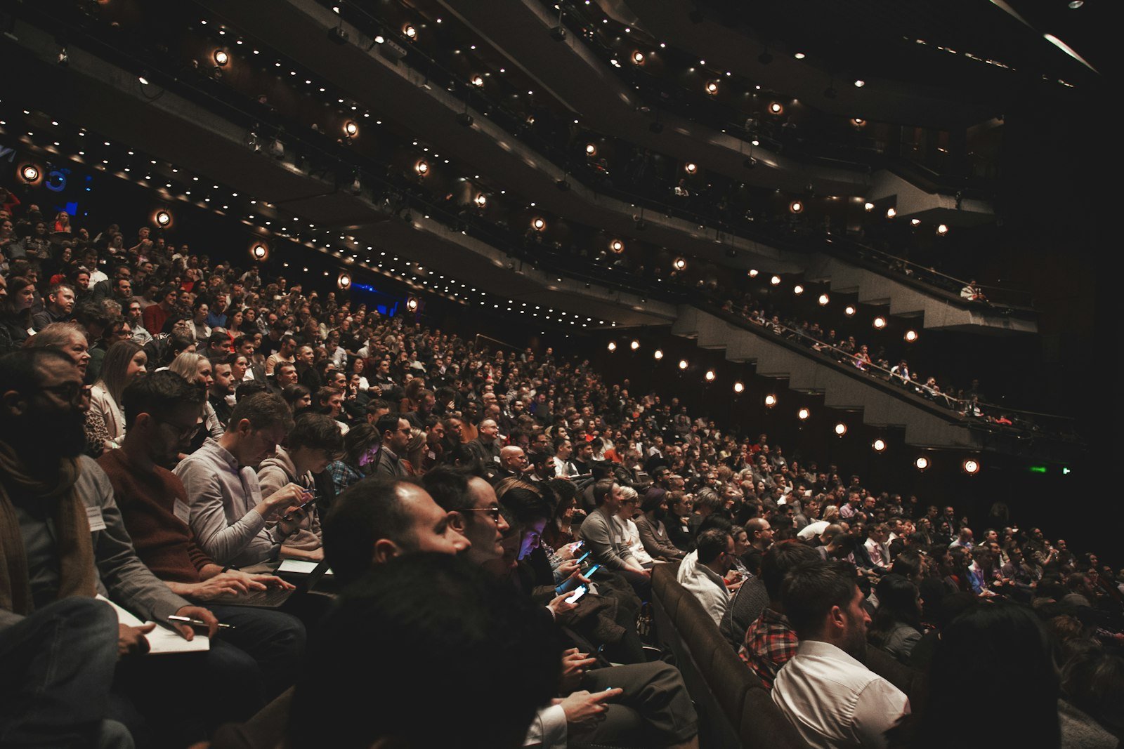 Packed multi-tier theatre auditorium during a live show