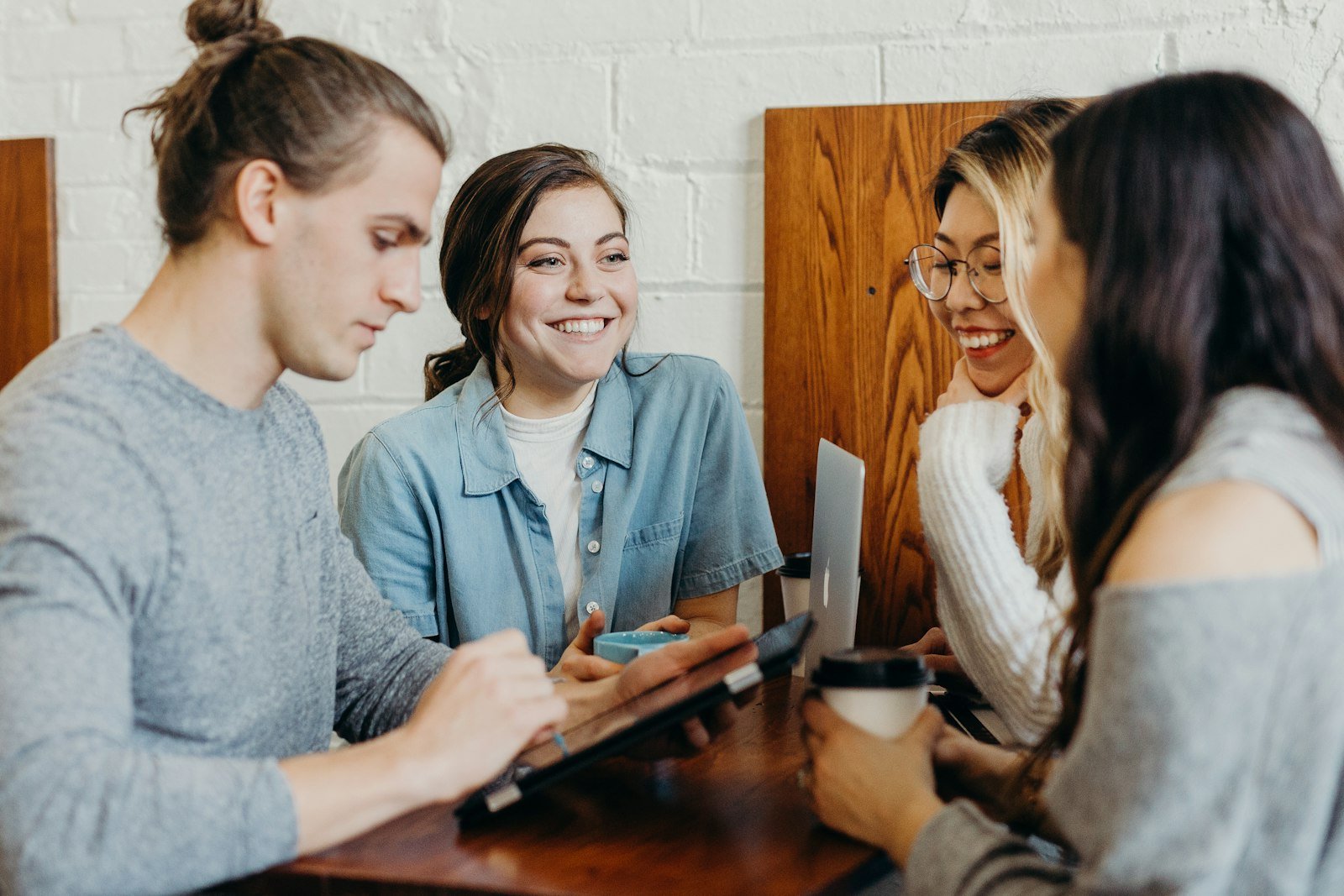 Group of friends laughing together at a table