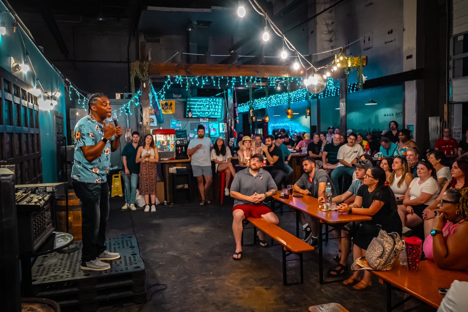 Comedian performing to a full crowd at a live comedy show